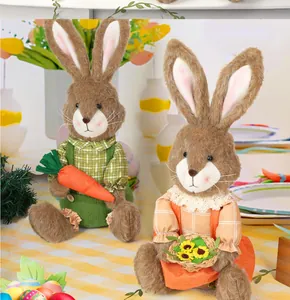Detail of plush Easter bunny figurines holding a carrot and a sunflower basket decor