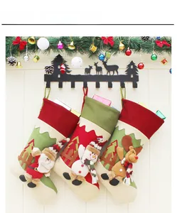 Detailed view of 3D Santa, Snowman, and Reindeer Christmas stockings hanging on hooks