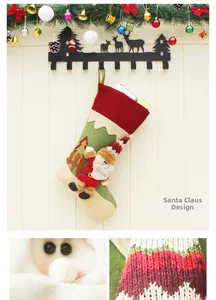 Detail of fabric Santa Christmas stocking with 3D figure on festive wooden background