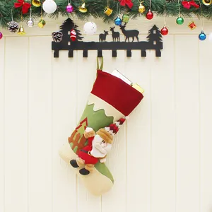 Classic red Christmas stocking with 3D Santa Claus figure hanging on a wooden wall