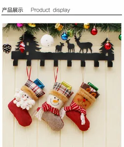 Detailed view of Christmas stocking set with Santa, snowman and deer on metal reindeer hook