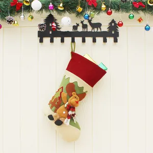 Christmas stocking with 3D reindeer decor and green tree patch hanging on forest wall