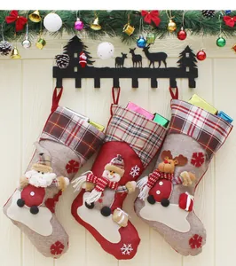 Close-up of Santa, Snowman, and Reindeer 3D dolls on Christmas stocking details