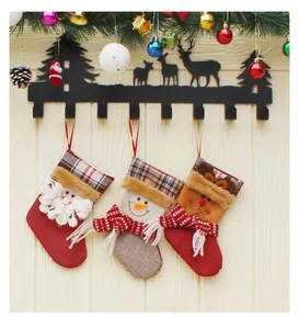 Three 3D festive Christmas stockings hanging on a black metal reindeer wall hook rack