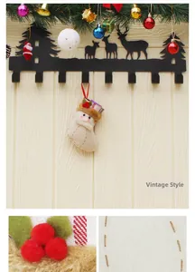 Detail of black metal wall hook with reindeer forest silhouette and Santa Claus stocking