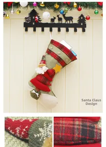 Detail of green knit Christmas stocking with Santa appliqué and red plaid cuff texture