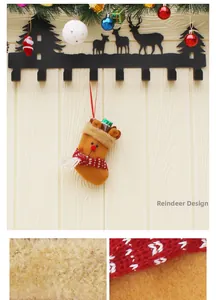 Detail of plush reindeer Christmas stocking hanging on a black metal wall hook with deer silhouette