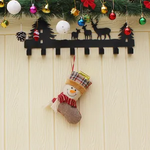 Reindeer metal wall hooks with snowman Christmas stocking and festive pine needle ornaments
