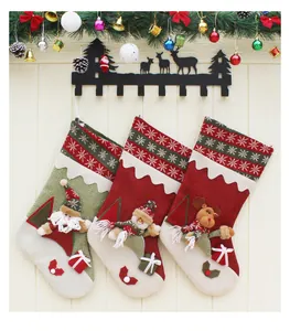 Hanging knitted Christmas stockings with 3D Santa, snowman and reindeer character appliques