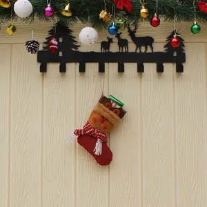 Christmas stocking wall rack with reindeer silhouette and festive pine decorations