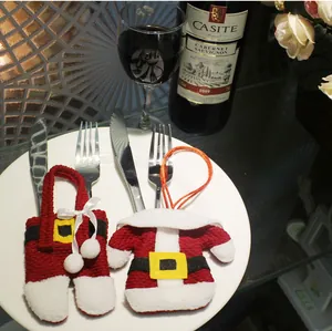 Christmas cutlery holder set with Santa jacket and pants design on festive table