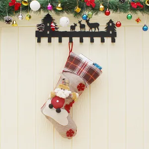 Large burlap Christmas stocking with Santa Claus doll and red plaid cuff decoration