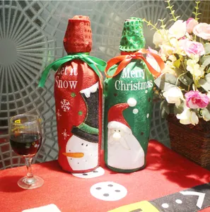 Detail of Christmas wine bottle covers featuring Santa Claus and snowman with bow ribbons