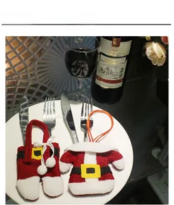 Christmas Santa suit cutlery holder on white plate for festive dining table decoration