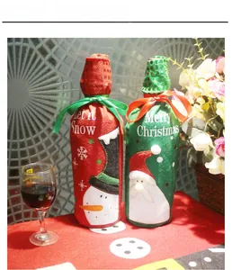 Detail of Christmas wine bottle covers with felt embroidery and sequin accents