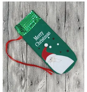 Close-up of green Christmas gift bag with Santa Claus embroidery and Merry Christmas text