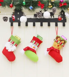 Detailed close-up of three Christmas gift stockings hanging on festive elk hooks