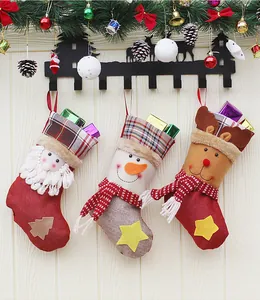 Three 3D Christmas stockings with Santa, Snowman and Reindeer hanging on hooks