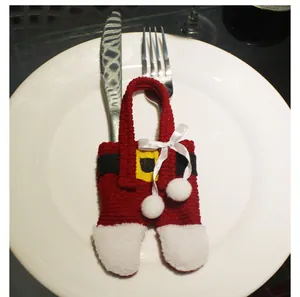 Detail of Santa pants cutlery holder in red knit fabric with white faux fur trim
