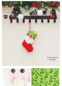 Detail of red Santa Claus Christmas stocking with green knit cuff and hanging loop