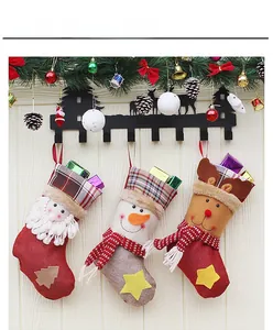 Detailed view of 3D Christmas stockings with Santa, snowman and elk on a festive mantel