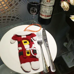 Christmas Santa suit cutlery holder placed on white porcelain plate for festive table decor