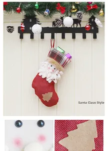 Detail of red Christmas stocking with 3D Santa motif, plaid cuff and tree patch