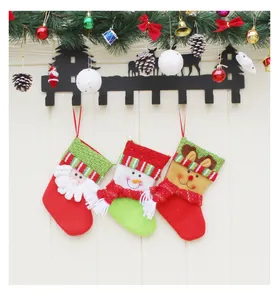 Three festive Christmas stockings with 3D Santa and snowman hanging on a wall hook