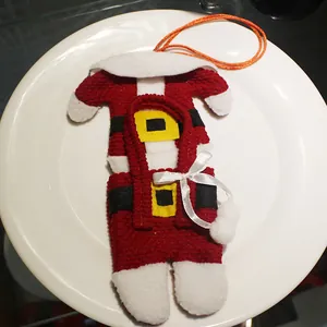 Christmas Santa suit cutlery holder set on a white ceramic plate for table decoration