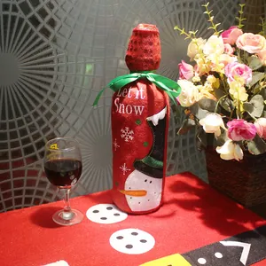 Christmas snowman wine bottle cover with Let it Snow lettering and green ribbon bow decoration