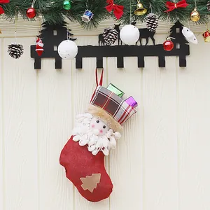 Hanging burlap Christmas stocking with plush Santa Claus and 3D gift boxes decoration