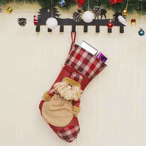 Christmas stocking with 3D Santa Claus and plaid details hanging on a festive wooden wall