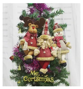 Close-up of Santa, reindeer, and snowman plush ornaments hanging on a Christmas tree