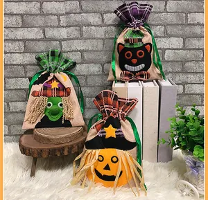 Detail of Halloween drawstring gift bags with pumpkin, witch, and cat designs