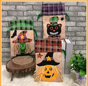 Detailed view of 3-pack Halloween drawstring gift bags with witch, cat and pumpkin icons