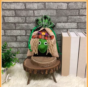 Detail of Halloween drawstring bag featuring a green witch cartoon and green plaid fabric