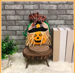 Detail of Halloween drawstring gift bag featuring a pumpkin scarecrow and red plaid trim