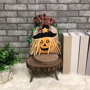 Halloween burlap gift bag with pumpkin and witch hat on a rustic wooden stand