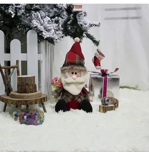 Close-up of sitting Santa Claus doll with red plaid hat and white beard for Xmas decor