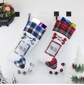 Detail of Christmas dog paw stockings with photo frames in red and blue plaid patterns