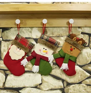 Detailed view of three mini Christmas stockings with Santa, snowman and reindeer designs