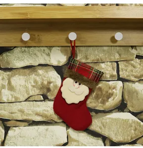 Detail of mini red velvet Christmas stocking with 3D Santa Claus and red-green plaid cuff