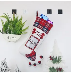 Detail of dog paw Christmas stocking with photo insert slot and red buffalo plaid accents