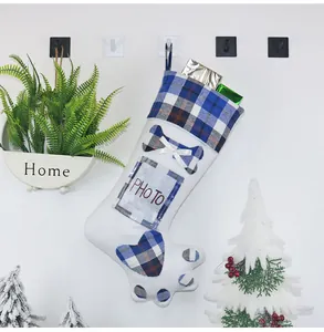 Detailed view of paw-shaped Christmas stocking with photo pocket and plaid patterns