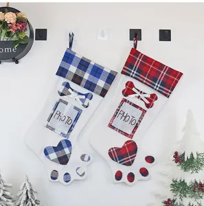 Detail of Christmas dog paw stockings with photo slot and plaid pattern appliques