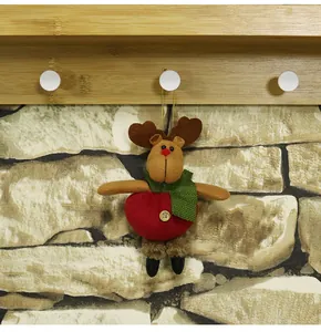 Dettaglio di una decorazione natalizia a renna in peluche con sciarpa verde