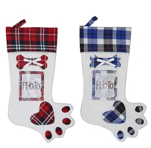 Detail of plaid pet paw Christmas stockings with clear photo slots and bone decorations