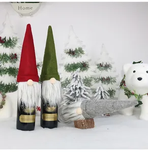 Close-up of three festive Christmas gnome wine bottle covers in red, green and grey