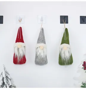 Three hanging Christmas gnomes in red, green, and gray felt with long white beards