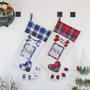 Christmas paw shaped stocking with photo slot and plaid pattern hanging on a tree